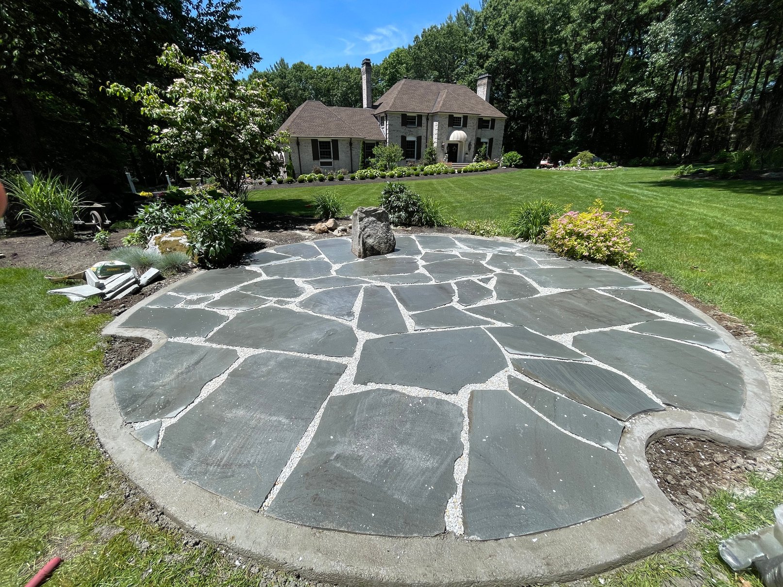a stone patio in front of a house